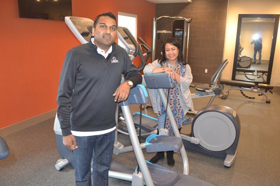 Owner A.J. Patel and Rosie Marshall show off the fitness center in the new Hilton Homes2Suites Hotel located on Glendale Avenue in Hanford.